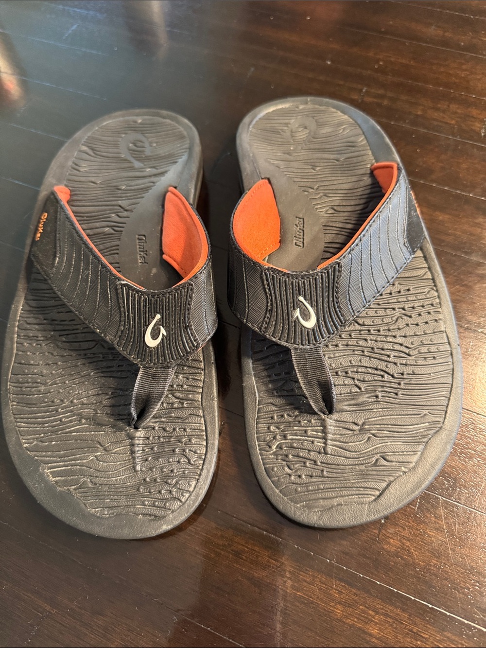 OluKai Men's Black Flip-Flops with Orange Accents